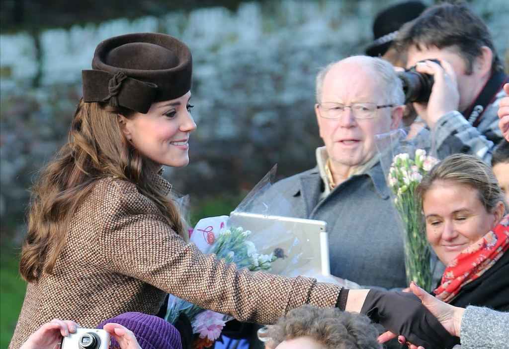 Wellwishers give the Royals flowers and cards outside after the church service. The Duchess of Cambridge greets the public in 2014. I-images