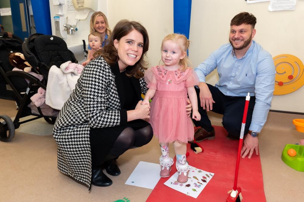 HRH Princess Eugenie and Posie Aurora Sadler-Smith and dad, Dominic. (Royal National Orthopaedic Hospital Charity).