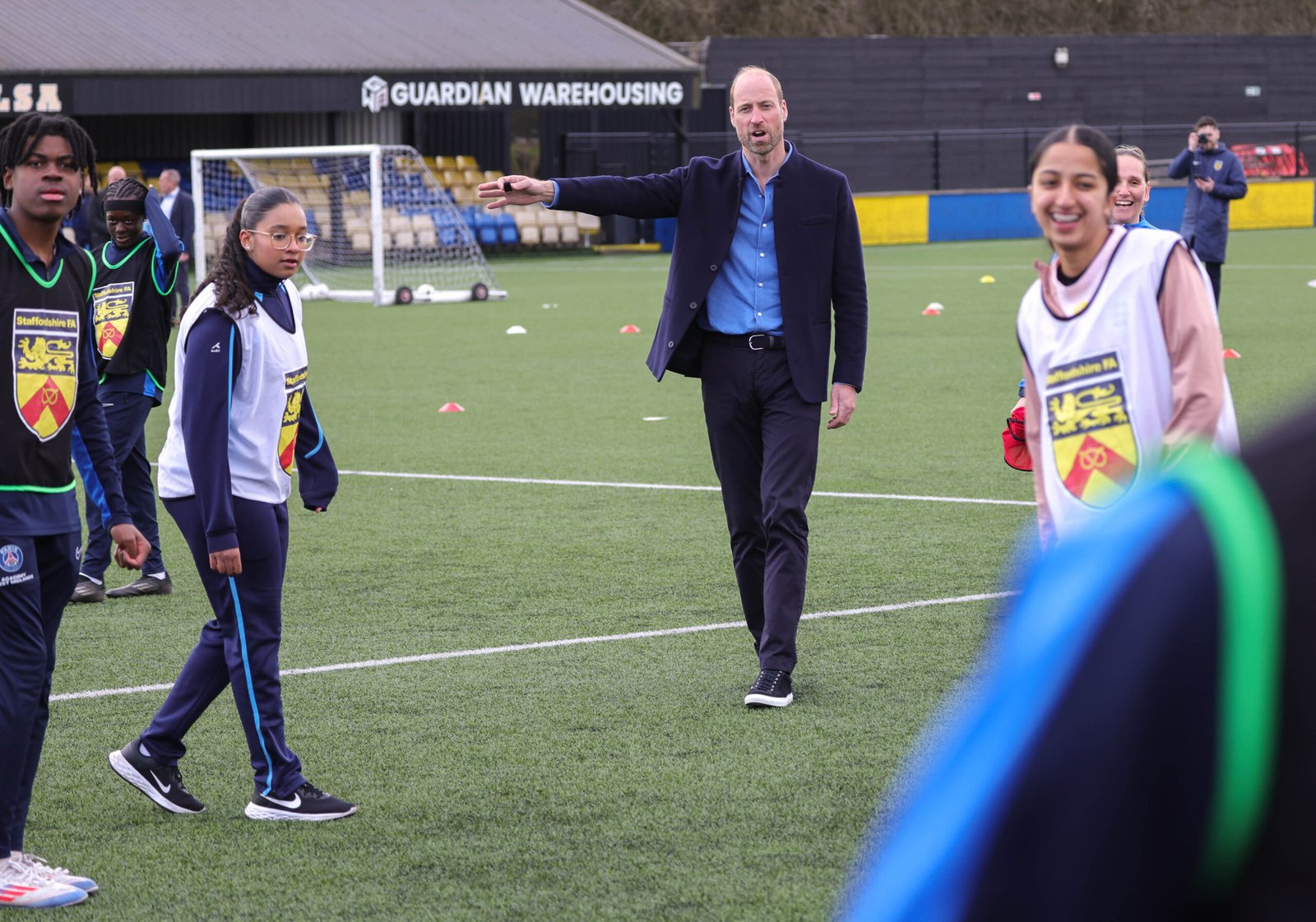 11/03/2025. Willenhall, UK. The Prince of Wales, Patron of the Football Association during a visit to a referee training course at Sporting Khalsa FC as part of the FA’s Reflective and Representative campaign which aims to recruit 1,000 people from Black, Asian and Mixed Heritage backgrounds into refereeing roles. The Prince met representatives from the FA and Sporting Khalsa and heard about the importance of opening up opportunities in football to young people from diverse backgrounds. His Royal Highness then spoke to trainers of the refereeing course and professional referee and Lieutenant in the British Army, Levi Gray. His Royal Highness then joined a lesson with participants on the course and learned about the key skills involved in refereeing. The Prince will be taken onto the pitch to engage with different stations teaching referee skills such as whistle tones and flag signals. His Royal Highness will then have the opportunity to practice being a referee in a mini football game alongside participants on the programme. Picture by Andrew Parsons / Kensington Palace