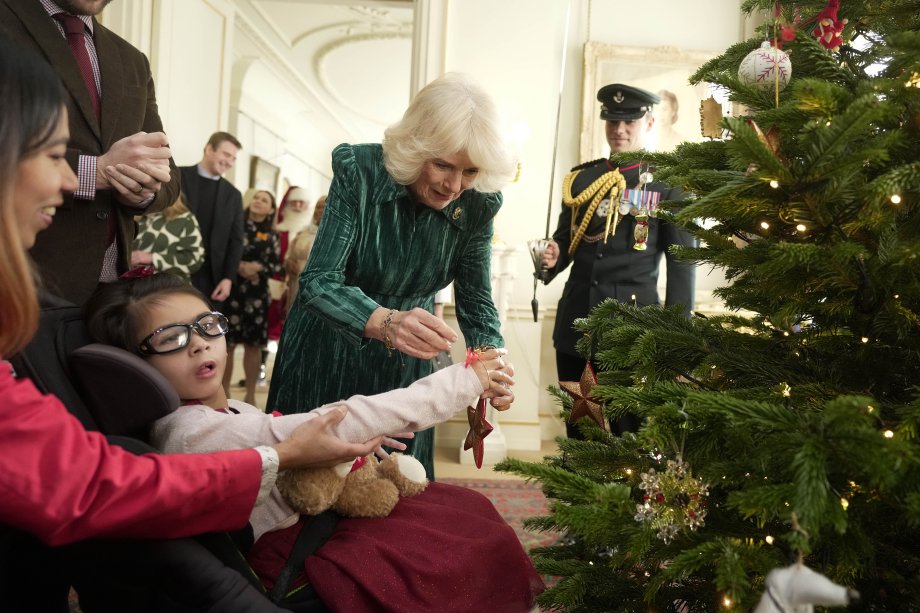 Queen Camilla decorating a Christmas tree