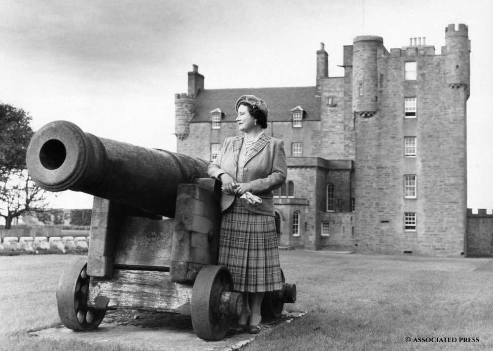 Queen Elizabeth, Queen Mother, stands by old cannon and in front of her Castle of Mey, near John O'Groats, northernmost Scotland on Oct. 20, 1955, during her holiday there. The cannon was obtained from an old coastal fort by the Earl of Caithness in 1820.