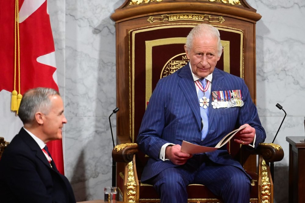Canadian Prime Minister Mark Carney listens as King Charles III delivers the Speech from the Throne on the Senate floor during the State Opening of the Parliament of Canada, Ottawa, as part of the royal two-day visit to Canada