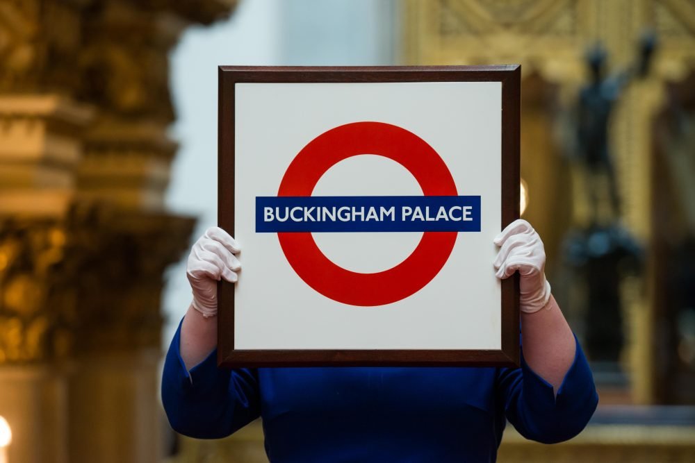 A Buckingham Palace London Underground sign, which was presented to Her Majesty during a visit to Aldgate East Tube Station in 2010.

Images for use only in connection with Royal Gifts at the Summer Opening of the State Rooms at Buckingham Palace, 22 July â 1 October 2017. Images must not be archived or sold-on. 

Royal Collection Trust / Â© Her Majesty Queen Elizabeth II 2017. 

Single use only; not to be archived or passed on to third parties.