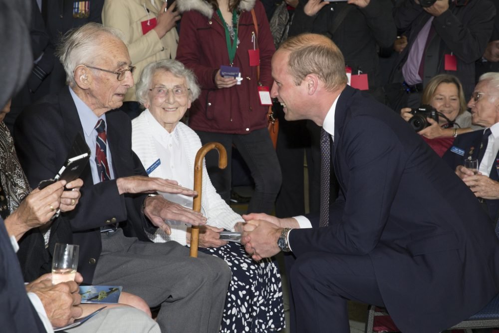 Prince William speaks to a veteran alongside Ms Wynn Goldthorpe-Baker a veteran ground crew member, at the Battle of Britain Memorial Flight (BBMF) RAF Coningsby 60th Anniversary Celebration. (MoD)