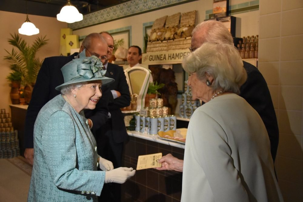 The Queen views a ration pack as presented by Lord and Lady Sainsbury, and learns more about the work which was done with the government to develop the rationing process when goods were in short supply during the Second World War. (royal family)