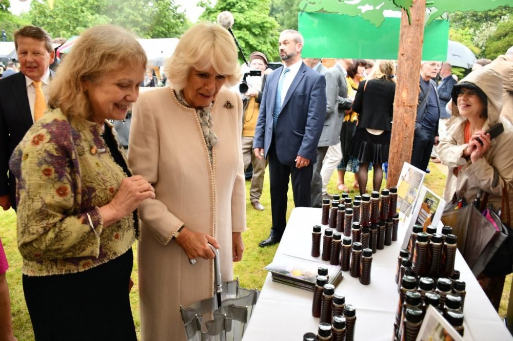 camilla browses the honey products (clarence house)