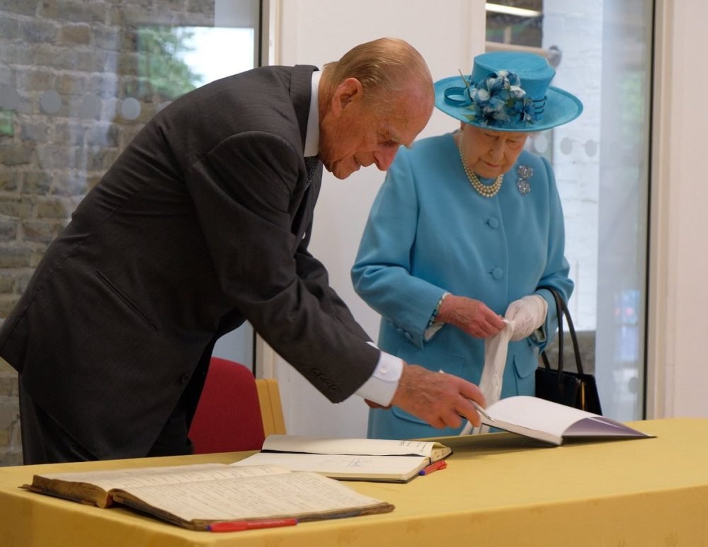 The Queen and Prince Philip sign the visitor's book at Mayflower Primary School, which was bombed in WWII, then called Upper North Street School (Royal Family)