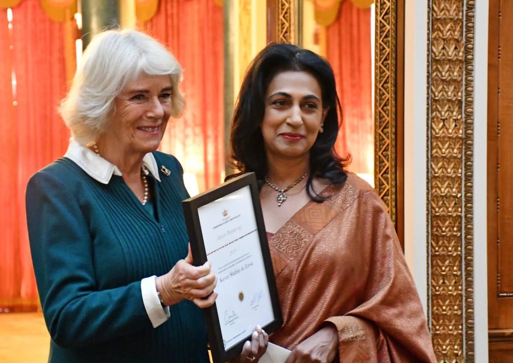 The Duchess of Cornwall hands Kieran 's mother his certificate (Clarence House)
