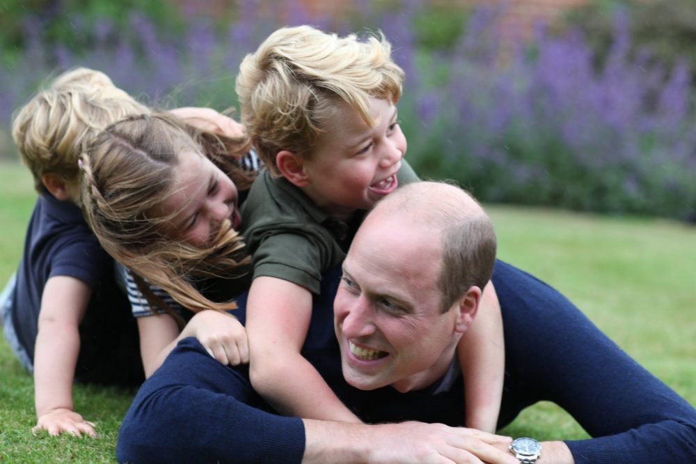 The Duke of Cambridge rolls around on the grass with Prince George, Princess Charlotte and Prince Louis