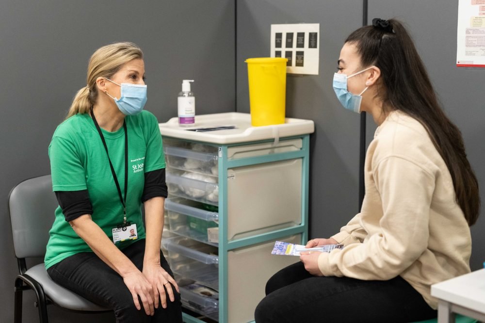 Sophie gives information to patients before they receive their vaccine; The Countess of Wessex is volunteering with St John's Ambulance (Daniel Lewis/St John Ambulance)