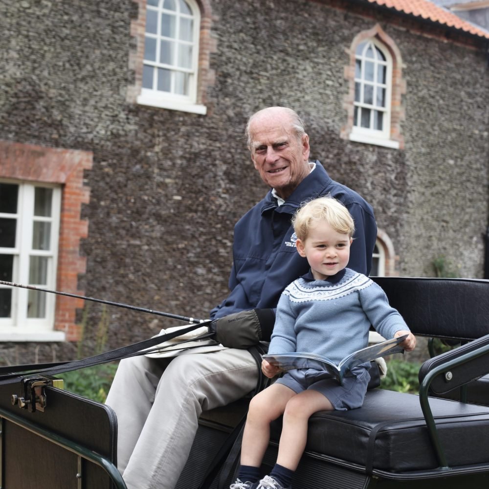 Prince George enjoys a carriage ride with The Duke of Edinburgh in 2015