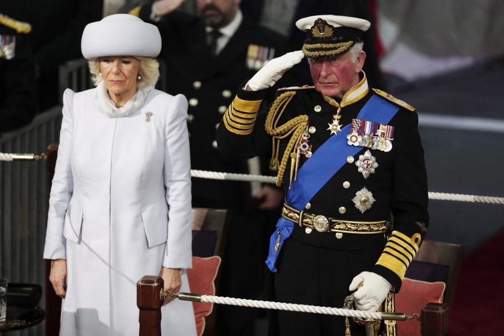 Pictured is HRH The Prince of Wales taking the Royal salute alongside HRH The Duchess of Cornwall during the commissioning.

COMMISSIONING DAY FOR HMS PRINCE OF WALES

The Royal Navys second Queen Elizabeth Class aircraft carrier has been commissioned into the Fleet today as the largest warship ever built for the nation.

HRH The Duchess of Cornwall, as the ships Lady Sponsor, alongside HRH The Prince of Wales, presided over the ceremony at HM Naval Base Portsmouth this morning, to an audience of 2,000 from industry, allies, friends and families.

Commanding Officer, Captain Darren Houston, read the commissioning warrant to the crew and guests gathered in the hangar which will soon house F-35 jets and a variety of helicopters. Among those watching were the First Sea Lord, Admiral Tony Radakin, ambassadors from France and USA, and the commander of the US Sixth Fleet, Vice Admiral Lisa Franchetti.
