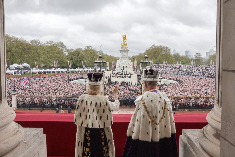 The King and Queen on the balcony of Buckingham Palace. (Royal Family).