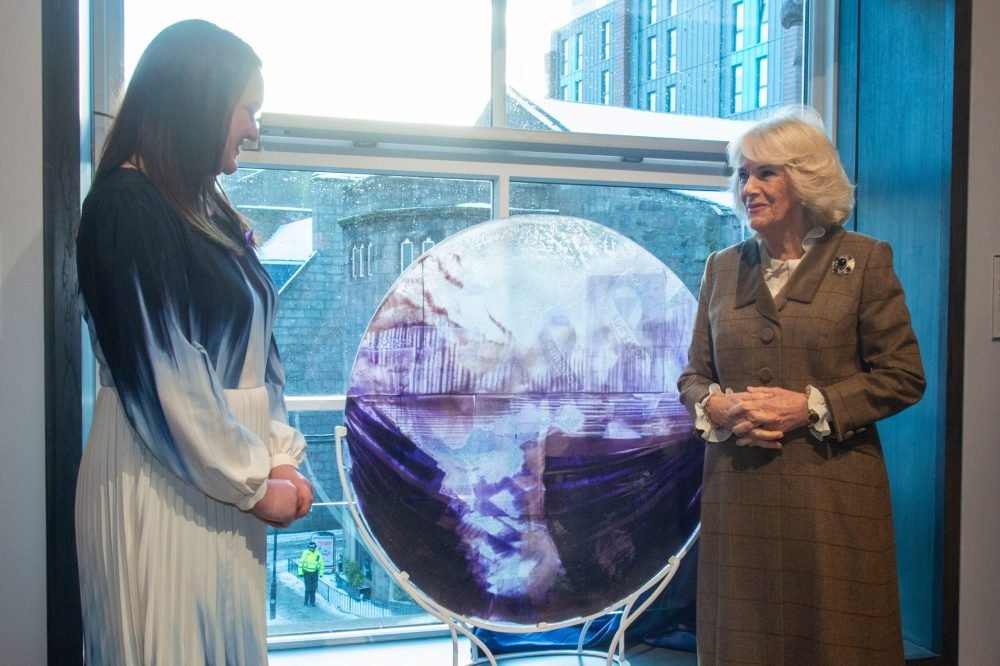 GEIX8PCXAAAK7hg Camilla standing next to the artwork which has been designed to indicate the gallery is a safe space for those experiencing domestic violence. (Royal Family).