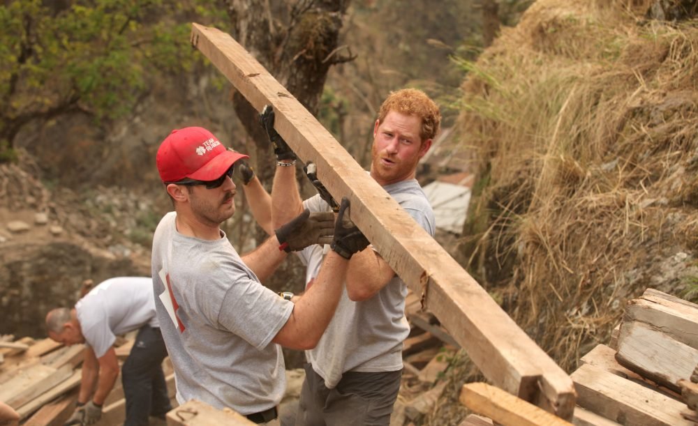 Prince Harry assists with wood for the school. Picture by : Becky Maynard, Team Rubicon UK / i-Images