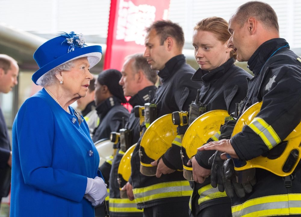 The Queen and Prince William meet firefighters during a visit to the Westway Sports Centre, London, which is providing temporary shelter for those who have been made homeless by the fire at Grenfell Tower. Picture by  i-Images / Pool)