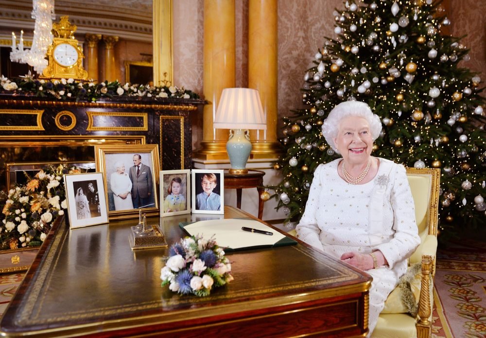 Image licensed to i-Images Picture Agency. 25/12/2017. London, United Kingdom. Queen Elizabeth II sits at a desk in the 1844 Room at Buckingham Palace, London, after recording her Christmas Day broadcast to the Commonwealth.  Picture by ROTA / i-Images