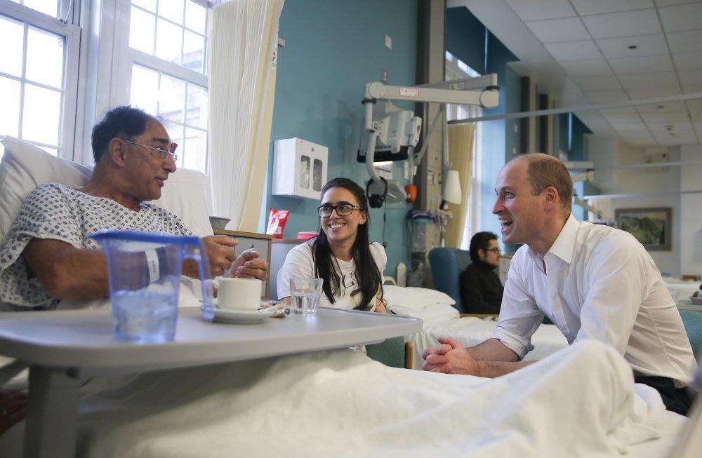 Prince William, Duke of Cambridge speaks to patient Vusof Omar (L) during his visit toThe Royal Marsden Hospital. Picture by  i-Images / Pool