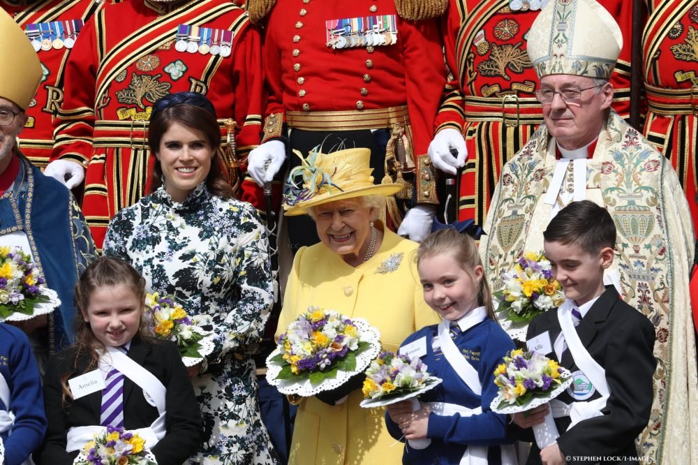 princess eugenie with her grandmother elizabeth ii in 2022 for royal maundy. they stand in front of uniformed men and hold posies