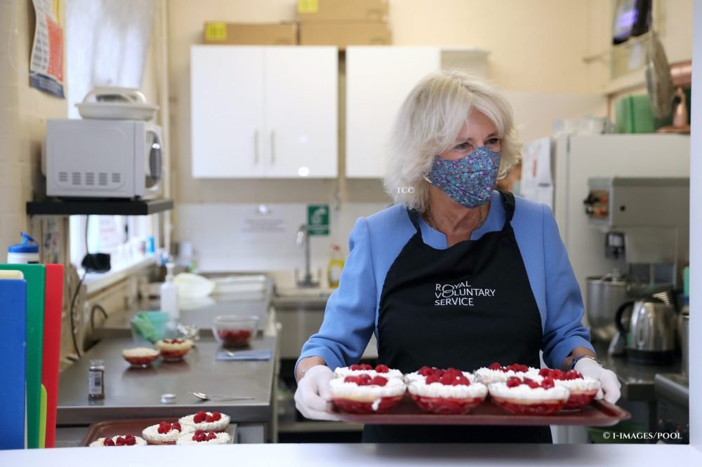Camilla, The Duchess of Cornwall, President of the Royal Voluntary Service, helps serve lunch during a visit at the Mill End lunch club in Rickmansworth in October 2020