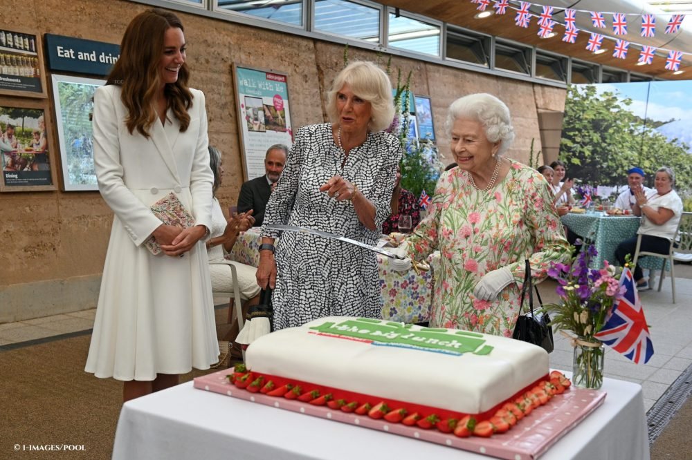 The Queen cuts a cake with Camilla, The Duchess of Cornwall and Kate, The Duchess of Cambridge at a reception in celebration of The Big Lunch initiative held at The Eden Project in Cornwall, during the G7 Summit, June 2021.