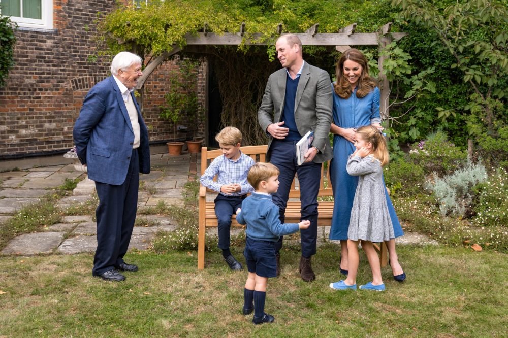 The Duke and Duchess of Cambridge, Prince George (seated), Princess Charlotte and Prince Louis with Sir David Attenborough in the gardens of Kensington Palace in London after The Duke and Sir David attended an outdoor screening of Sir David's upcoming feature film. (@KensingtonPalace/PA Wire)