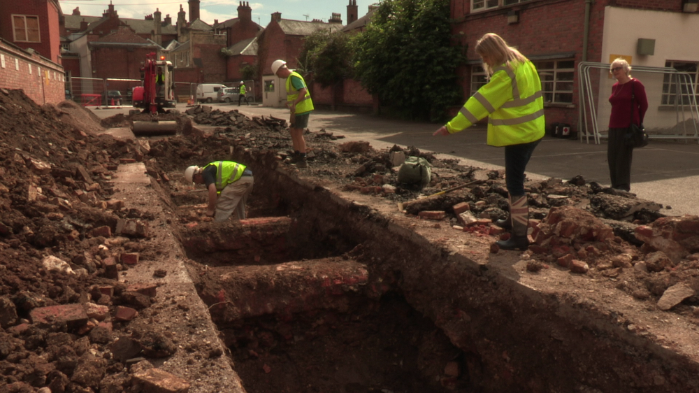 Philippa Langley observing the trench where a leg bone was found on the first day (Image courtesy of Richard III Society)