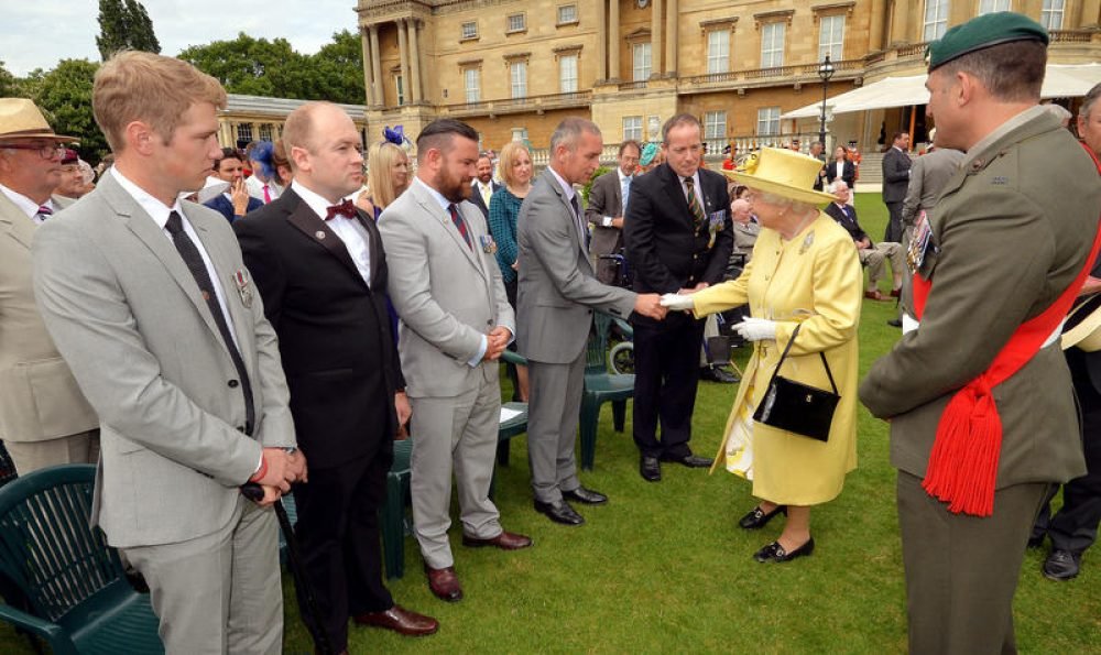 The Queen speaks to guests at a garden party. (John Stillwell/WPA Rota/Nunn Syndication/Polaris)