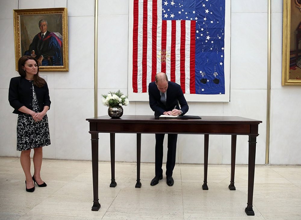 The Duke of Cambridge writes in the condolence book at the US Embassy. (PA)