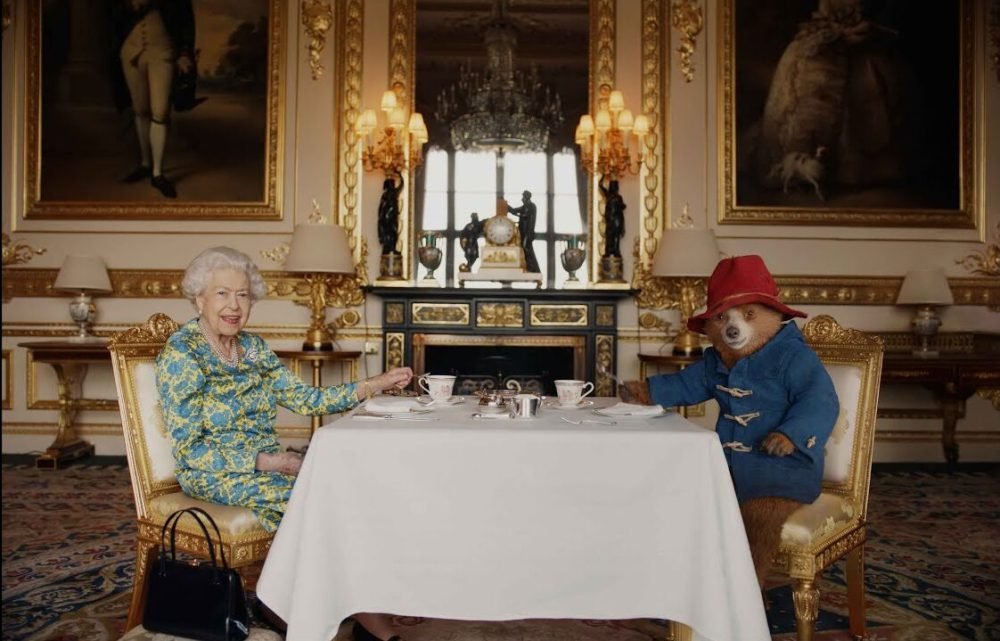 Elizabeth II with Paddington Bear. (Royal Family).