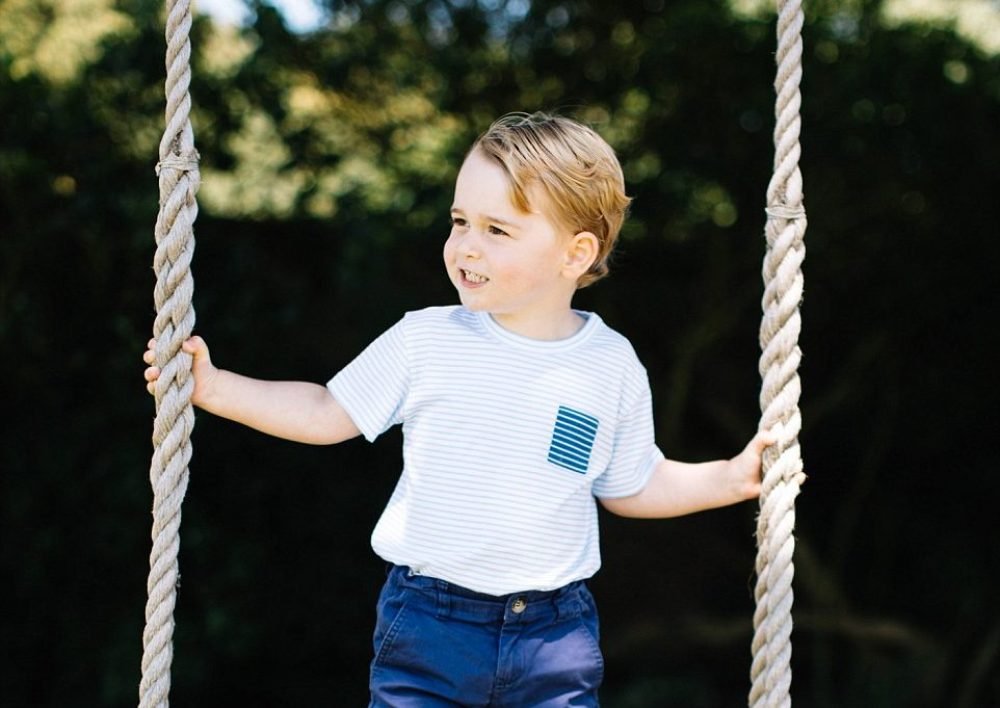 Prince George stands on a swing at Anmer Hall